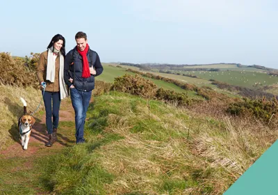 couple walking their dog